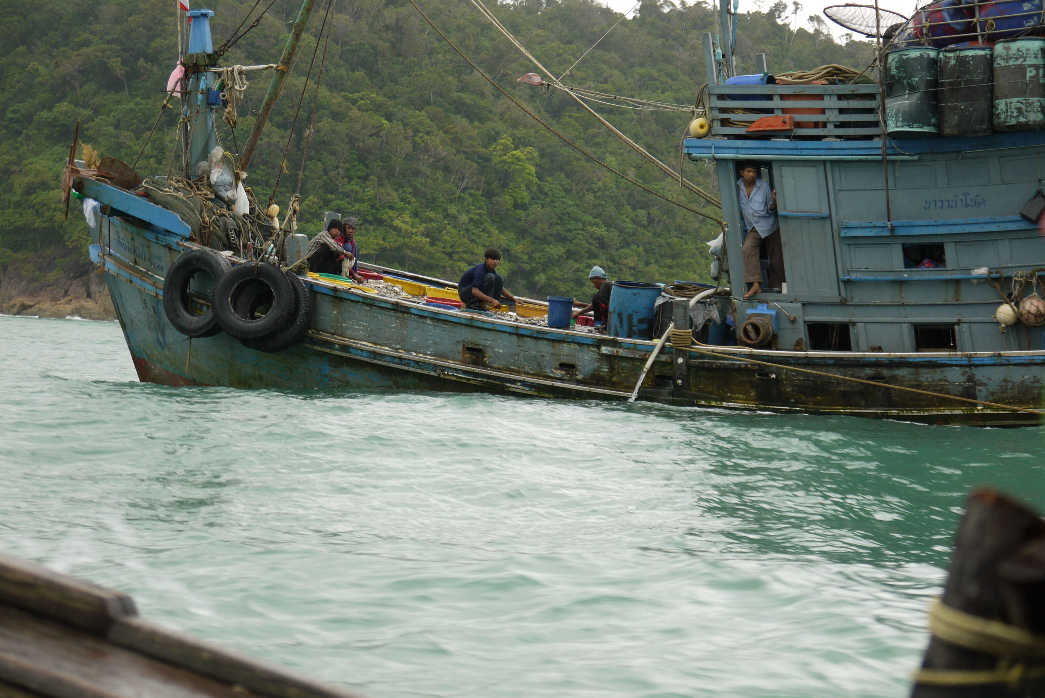 Migrant workers on a fishing boat on the Andaman coast of Thailand (Photo: Nathan Bennett)
